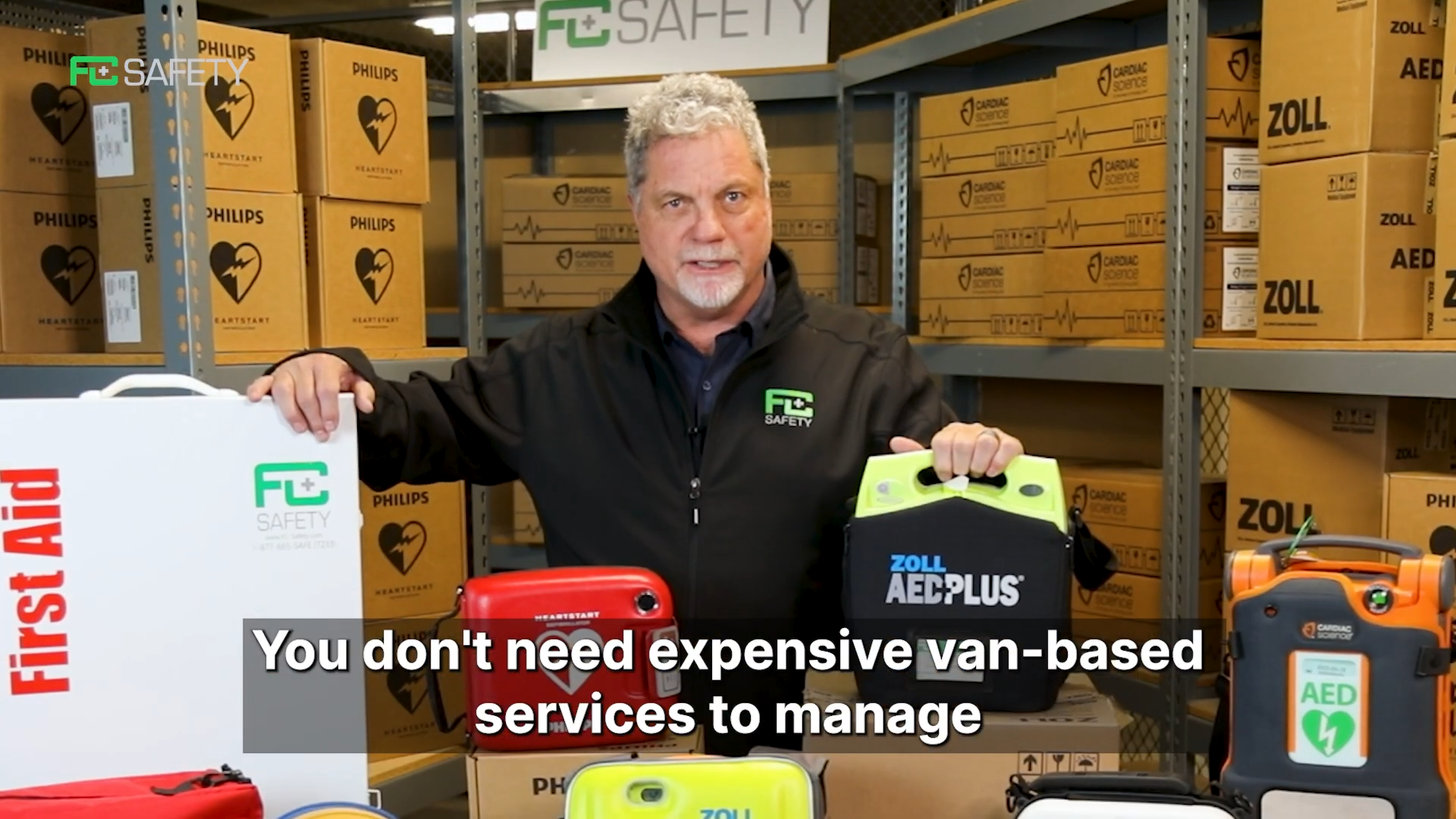 Load video: Thumbnail of a video with a man with a collection of AEDs and first aid equipment explaining why van-based services aren&#39;t needed.